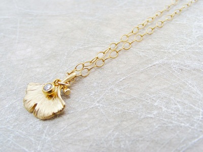 9ct gold 'Ginko' pendant with tiny natural diamond droplet, on fine 9ct gold chain.